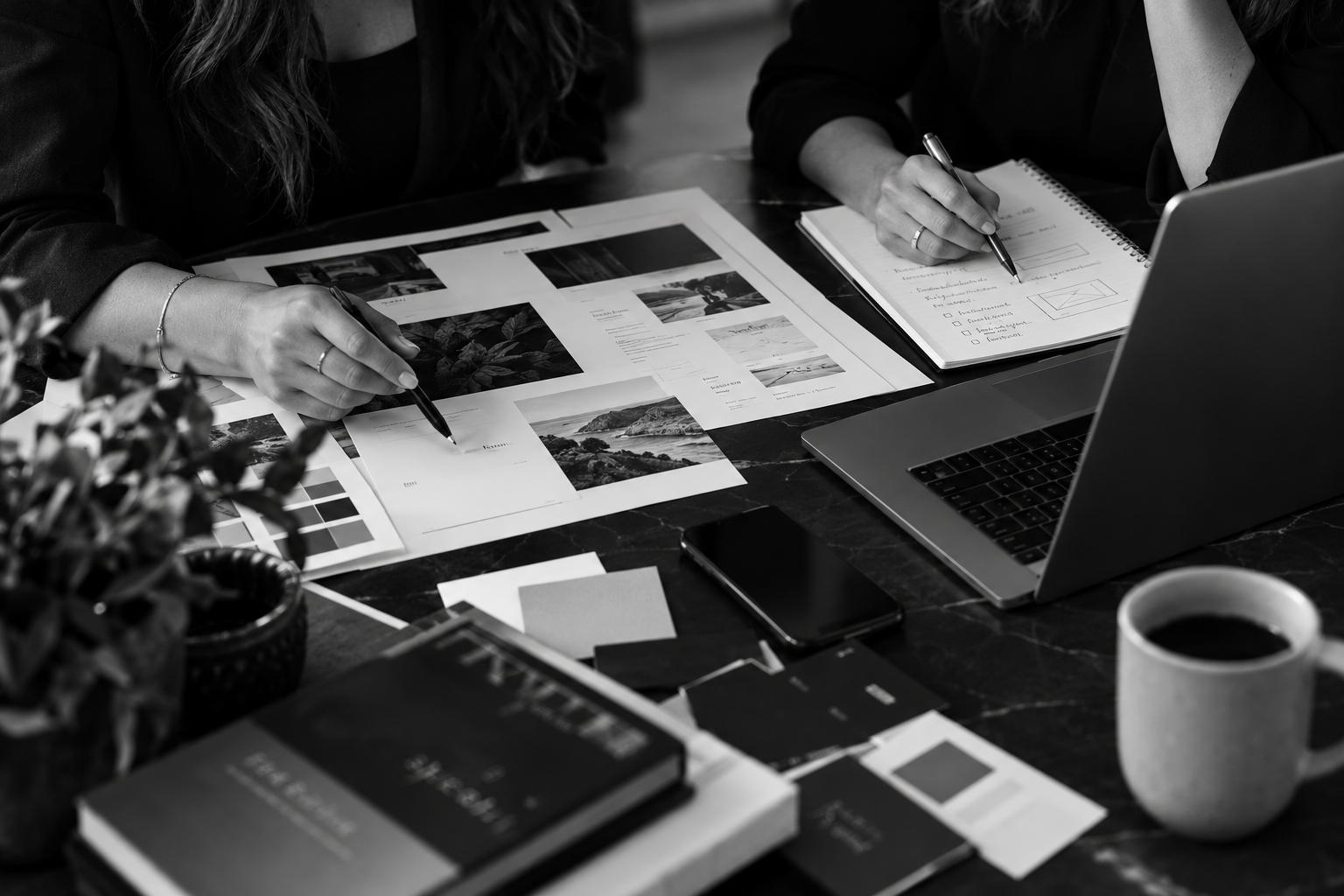 Creative professionals collaborating on website and brand strategy at a workspace.